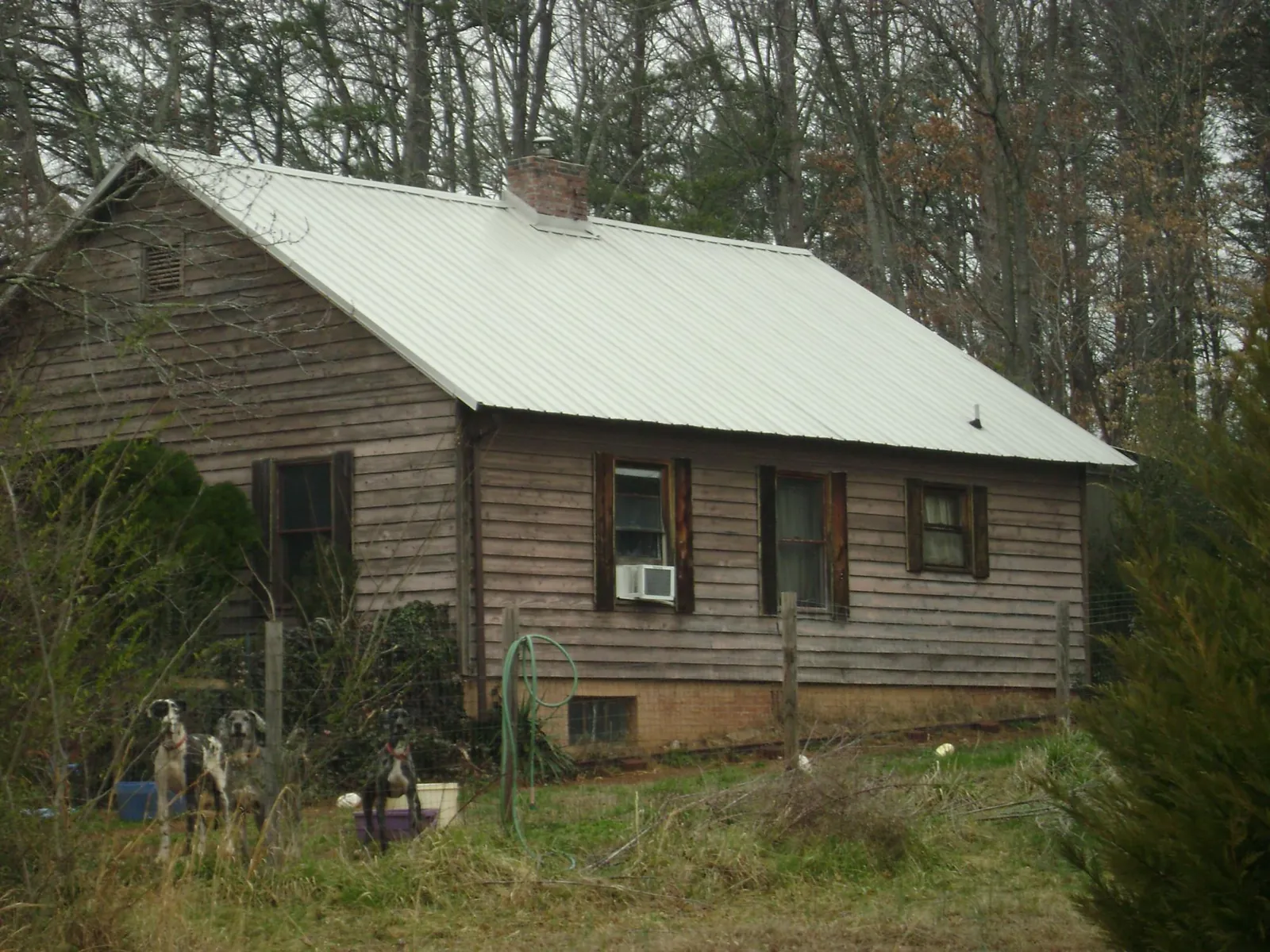 White metal roof on an old wood sided farmhouse, from a Metal Roof Installation job in Mount Blanchard